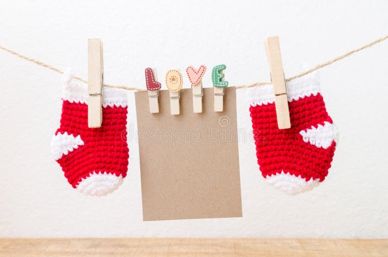 Blank paper with baby socks hanging on love clothesline