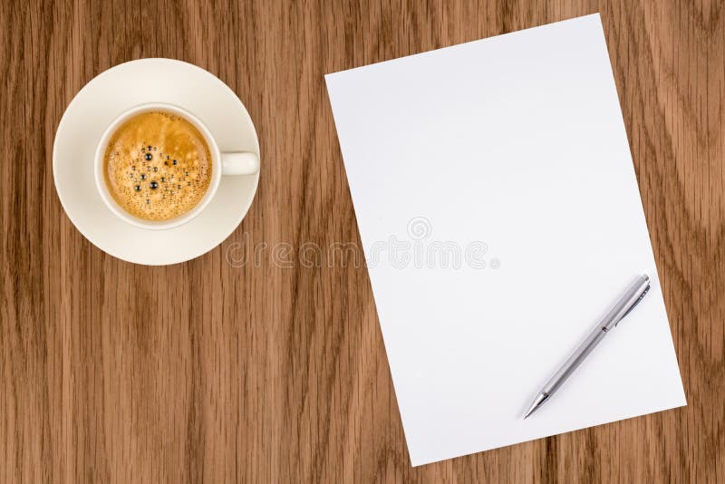 Blank paper with pen and coffee cup on wood table