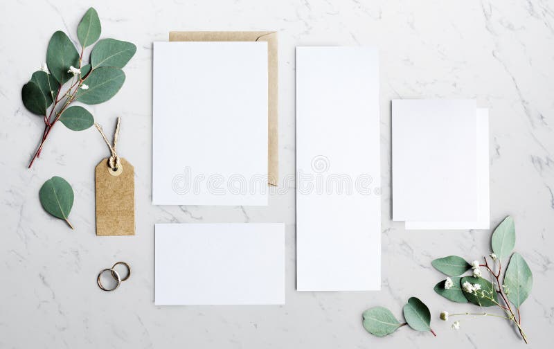 Blank Papers Laying on Marble Table With Leaves Decoration