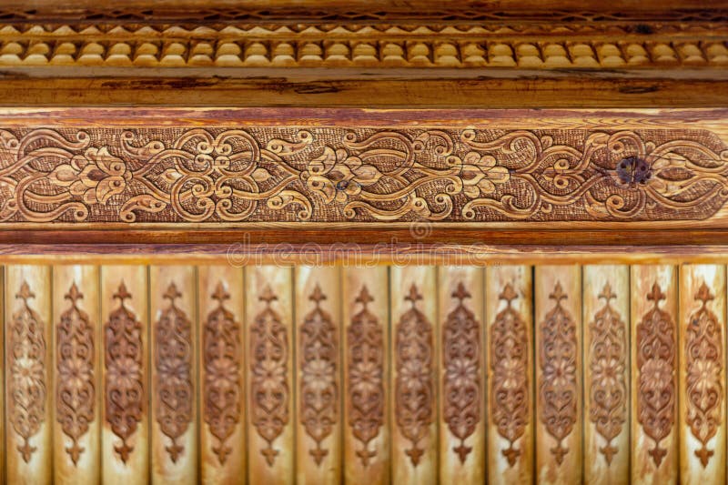 Blank pattern of decorative patterns carved on wooden elements of the interior with flowers, leaves, lines, rows. Hand-carved wood stock photography