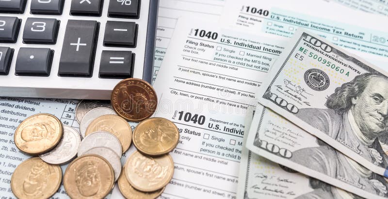 Blank personal income tax return with dollar bills and calculator and pen on calendar royalty free stock photography