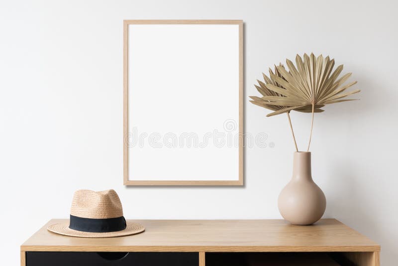 Blank picture frame mockup on white wall vertical template. Artwork in minimal interior design.