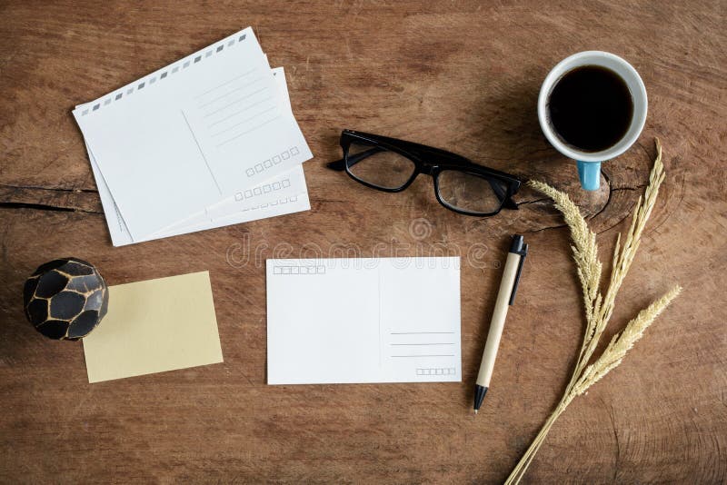 Blank postcard with coffee on wooden table