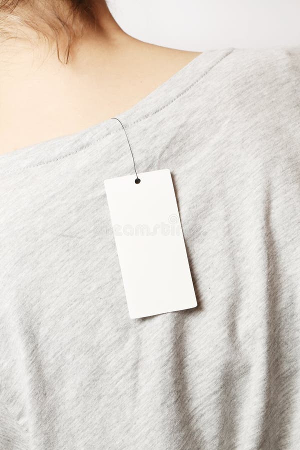 A Woman Looking the Tag on a Shirt · Free Stock Photo