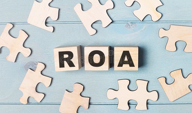 Blank puzzles and wooden cubes with the text ROA Return On Assets lie on a light blue background. Letters roa stock images, royalty-free photos and pictures