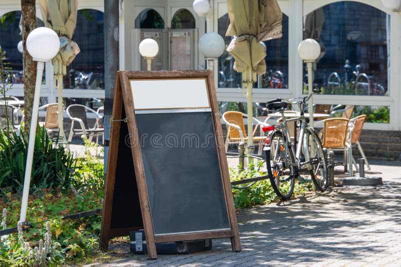 Blank restaurant shop sign or menu boards near the entrance to restaurant. Cafe menu on the street. Blackboard sign mockup in