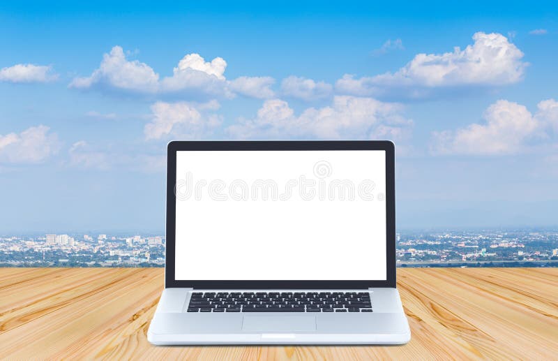 Blank screen laptop computer on wood floor with blue sky background stock photos