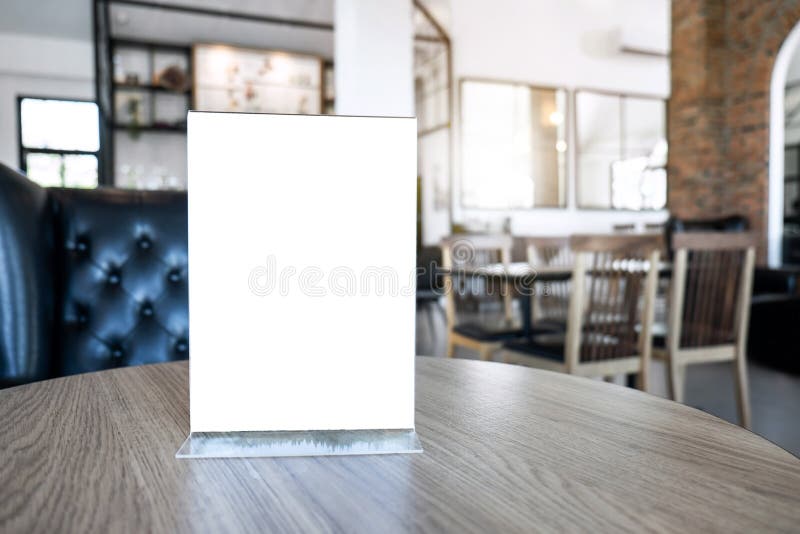 Blank screen mock up menu frame standing on wood table in coffee stock photography Blank screen mock up menu frame standing on wood table in coffee stock photography