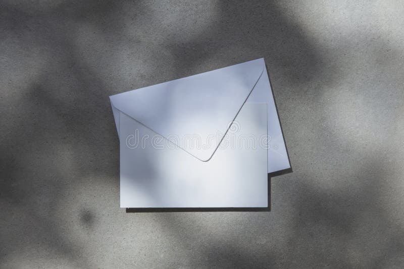 Blank White Invite or Postcard with Envelope Under Dappled Sunlight