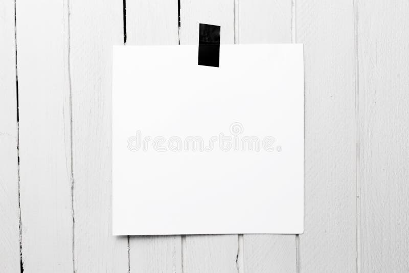 Blank white poster hanging on a tape on white wooden plank wall. Photo, business.