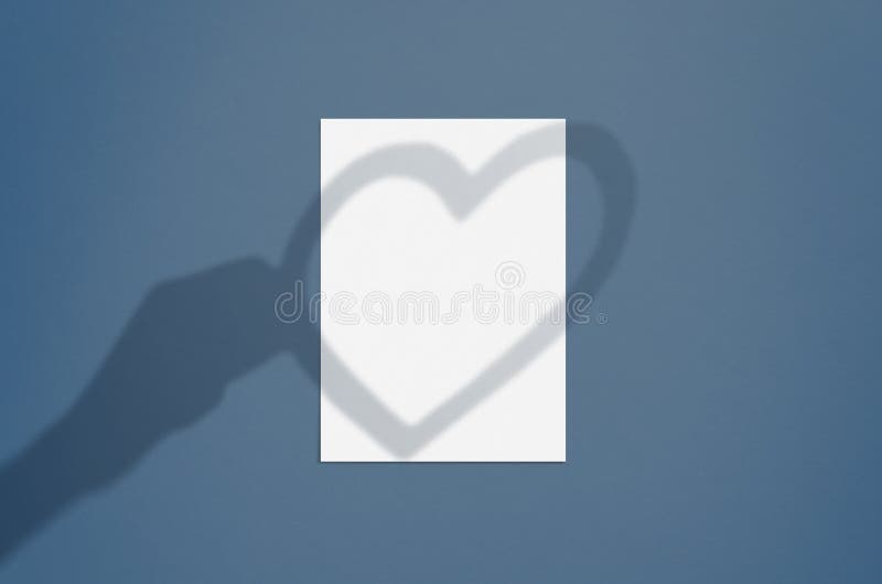 Blank white vertical paper sheet 5x7 inches with hand and heart shadow overlay. Modern and stylish valentine greeting card or