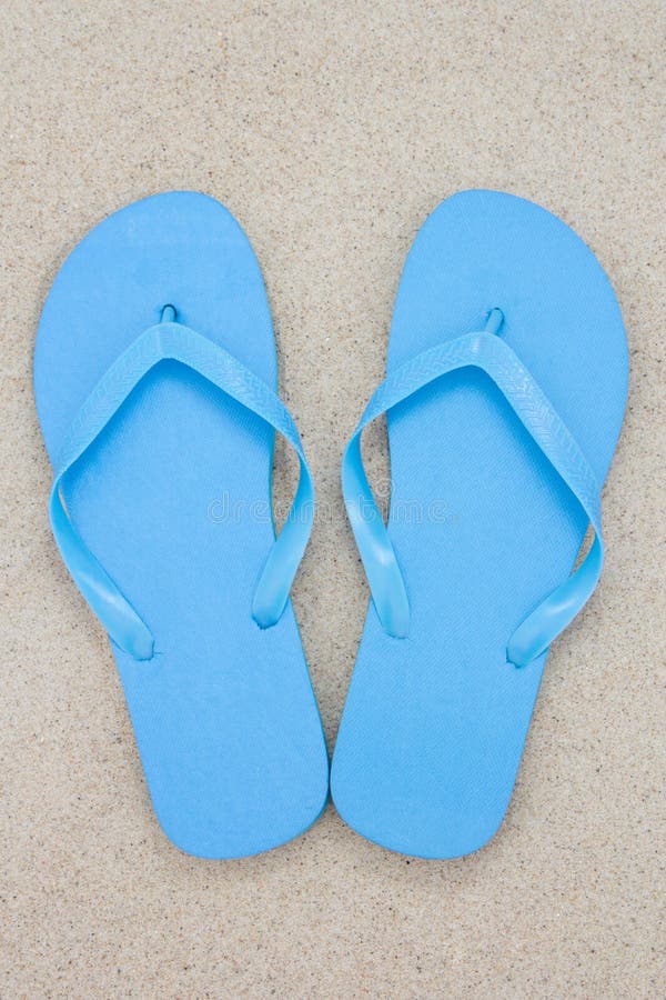 Blue flip flops on a sandy beach. Blue flip flops on a sandy beach