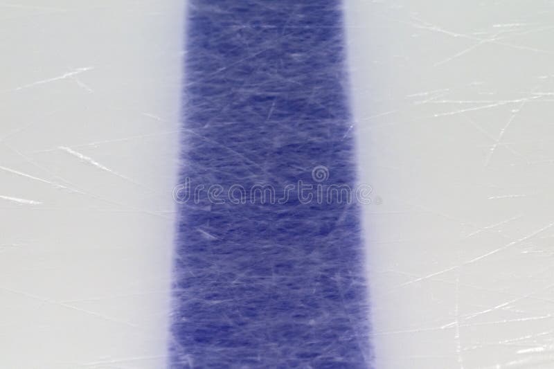 Ice hockey rink blue markings closeup, winter sport background. Ice hockey rink blue markings closeup, winter sport background.