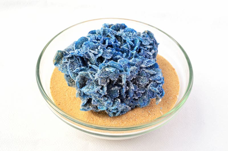 Piece of Sahara in a glass bowl - mineral blue desert rose on yellow Sahara sand. Piece of Sahara in a glass bowl - mineral blue desert rose on yellow Sahara sand