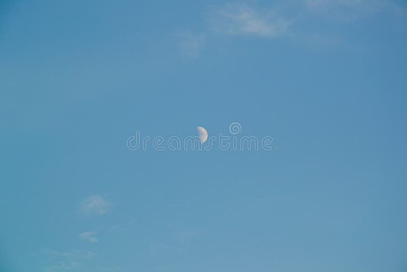 Moon on the clear blue sky with wispy passing clouds *RAW format available at request. Moon on the clear blue sky with wispy passing clouds *RAW format available at request