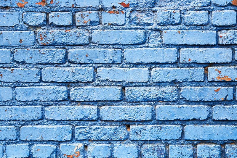 Brick wall that has been painted blue with peeling paint used as background texture pattern. Brick wall that has been painted blue with peeling paint used as background texture pattern.