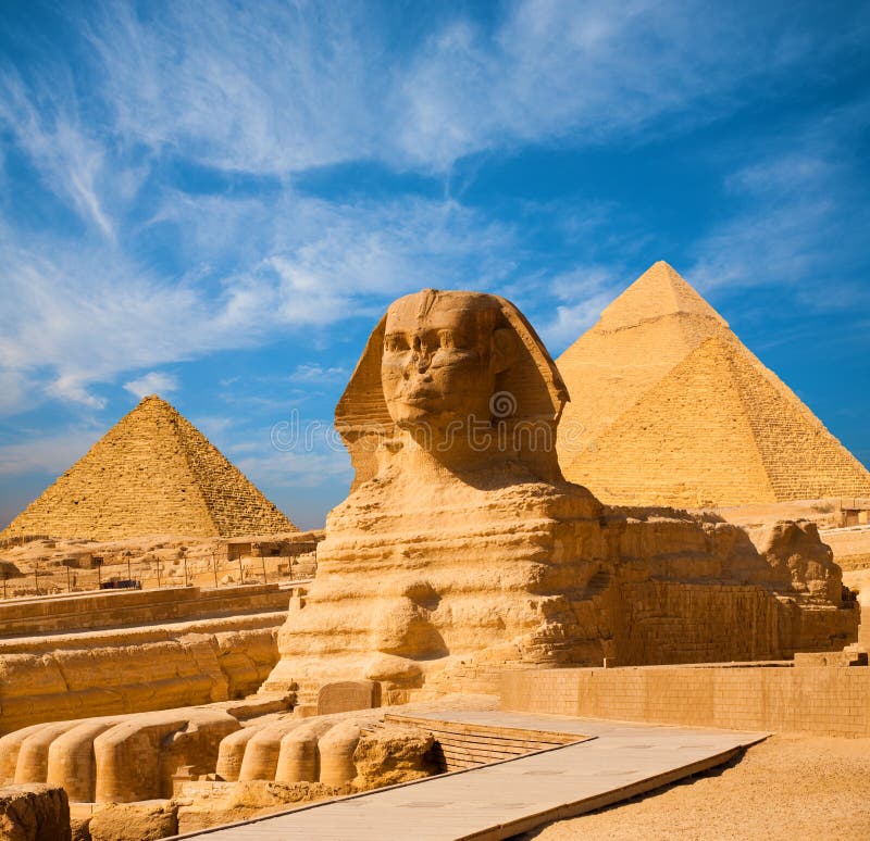 Egyptian Great Sphinx full body portrait with head, feet with all pyramids of Menkaure, Khafre, Khufu in background on a clear, blue sky day in Giza, Egypt empty with nobody. copy space. Egyptian Great Sphinx full body portrait with head, feet with all pyramids of Menkaure, Khafre, Khufu in background on a clear, blue sky day in Giza, Egypt empty with nobody. copy space