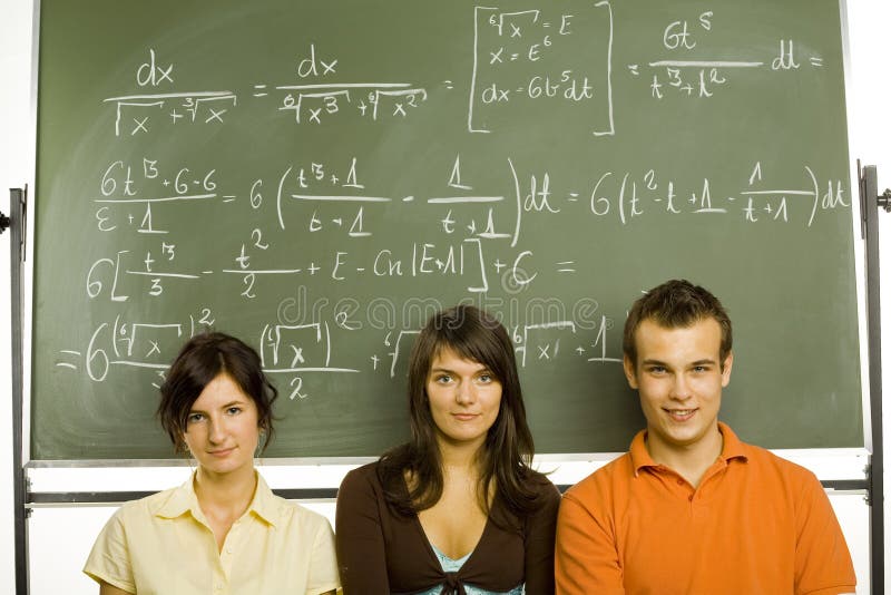 Small group of teenagers sitting in front of blackboard. Two girls and one boy. Looking at camera, front view. Small group of teenagers sitting in front of blackboard. Two girls and one boy. Looking at camera, front view