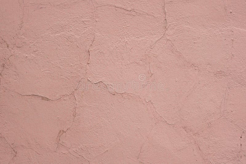 Cracked texture of plaster wall. Pink stucco close-up. Abstract background, interior decor. Cracked texture of plaster wall. Pink stucco close-up. Abstract background, interior decor.