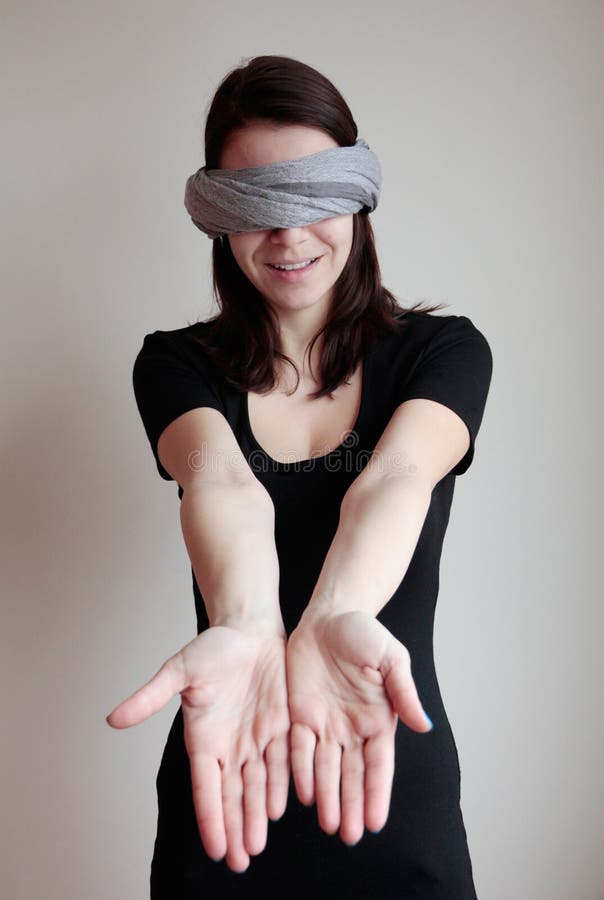 confused blindfolded woman on a white background Stock Photo