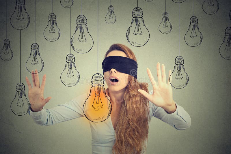 Blindfolded woman walking through light bulbs searching for bright idea