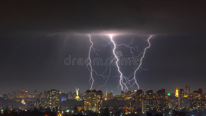 Lightning storm over the city at the summer heavy rain. Dramatic, breathtaking atmospheric natural phenomenon. Kyiv, Ukraine. Lightning storm over the city at the summer heavy rain. Dramatic, breathtaking atmospheric natural phenomenon. Kyiv, Ukraine