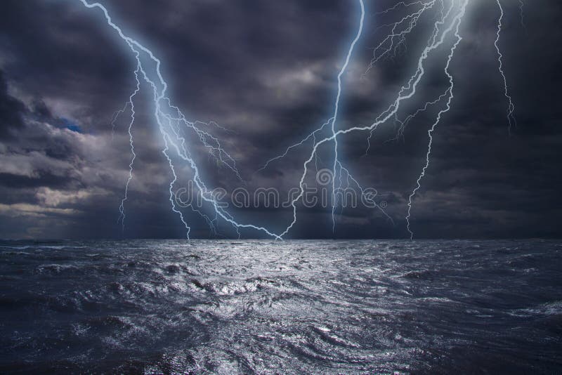 Lightning strike over the ocean. Bolt of lightning over stormy dark sea during a thunder-storm with dramatic cloudscape. Lightning strike over the ocean. Bolt of lightning over stormy dark sea during a thunder-storm with dramatic cloudscape