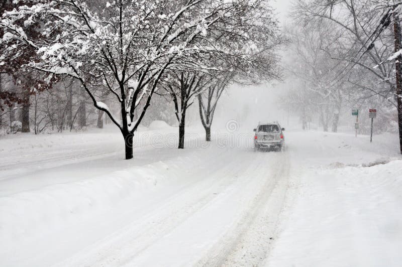 Lone car driving on snow covered street during the Blizzard of 2010 - Arlington VA. Lone car driving on snow covered street during the Blizzard of 2010 - Arlington VA