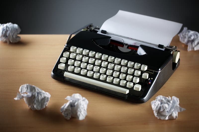 Frustration stress and writers block with old typewriter on desk and crumpled paper ball. Frustration stress and writers block with old typewriter on desk and crumpled paper ball