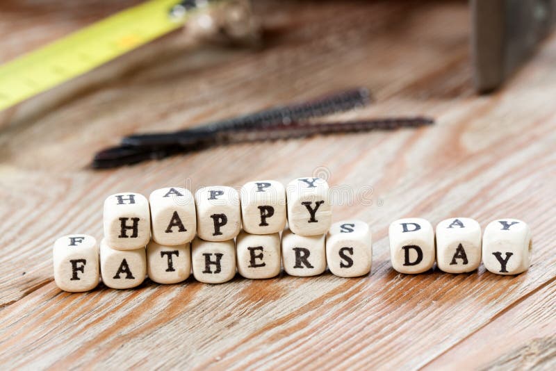 Happy Fathers Day blocks on a rustic wood background. Work tools concept. Happy Fathers Day blocks on a rustic wood background. Work tools concept.