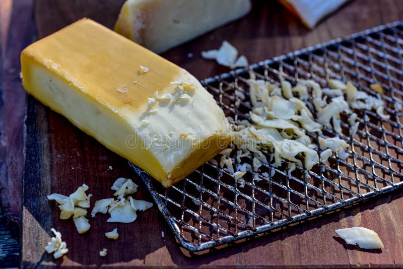 https://thumbs.dreamstime.com/b/block-smoked-cheese-partially-grated-vintage-metal-cheese-grater-wood-cutting-board-food-preparation-scene-block-240081174.jpg