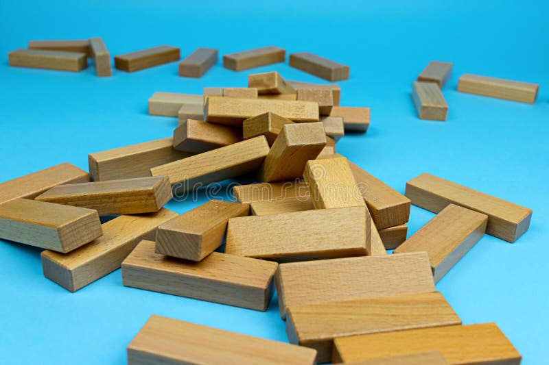 Wooden tower game. A collapsed wooden blocks tower. Games with family and friends. Leisure time. Wooden tower game. A collapsed wooden blocks tower. Games with family and friends. Leisure time.