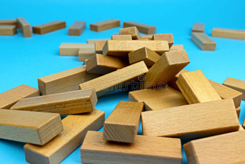 Wooden tower game. A collapsed wooden blocks tower. Games with family and friends. Leisure time. Wooden tower game. A collapsed wooden blocks tower. Games with family and friends. Leisure time.