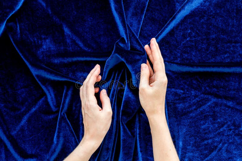 Abstract blue fabric texture pattern with hands top view royalty free stock photography