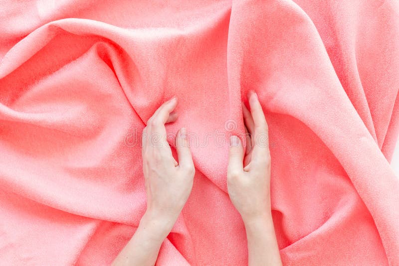 Abstract pink fabric texture pattern and hands top view stock photo