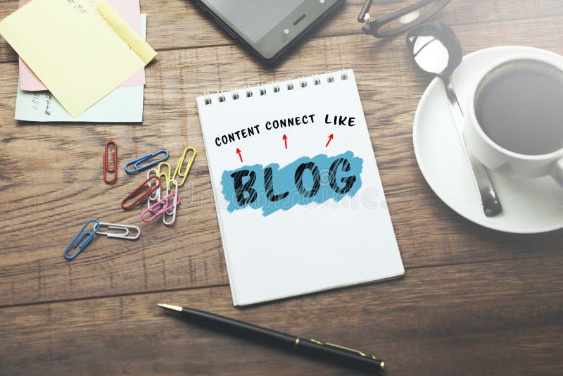 Blog text on notepad with phone on desk. royalty free stock images