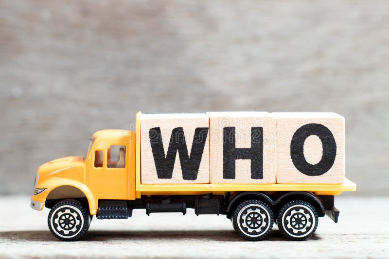 Truck hold letter block in word who on wood background. Truck hold letter block in word who on wood background