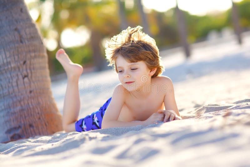 Blond adorable gorgeous little kid boy having fun on Miami beach, Key Biscayne. Happy healthy cute child playing with stock images Blond adorable gorgeous little kid boy having fun on Miami beach, Key Biscayne. Happy healthy cute child playing with stock images