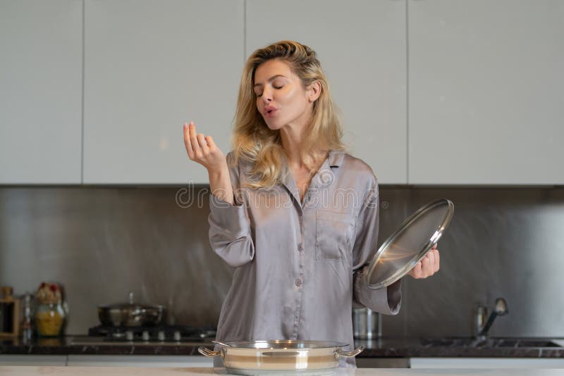 sexy and beautiful girl in lingerie in the kitchen preparing breakfast  Stock Photo