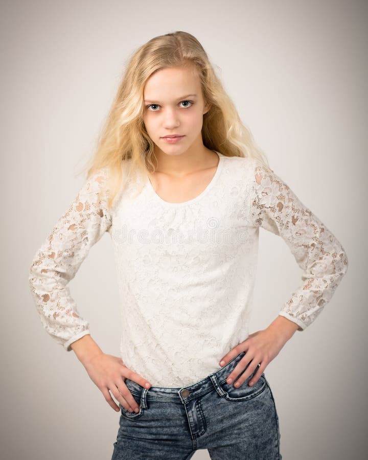 Blond Beautiful Teenage Girl In Jeans And White Top