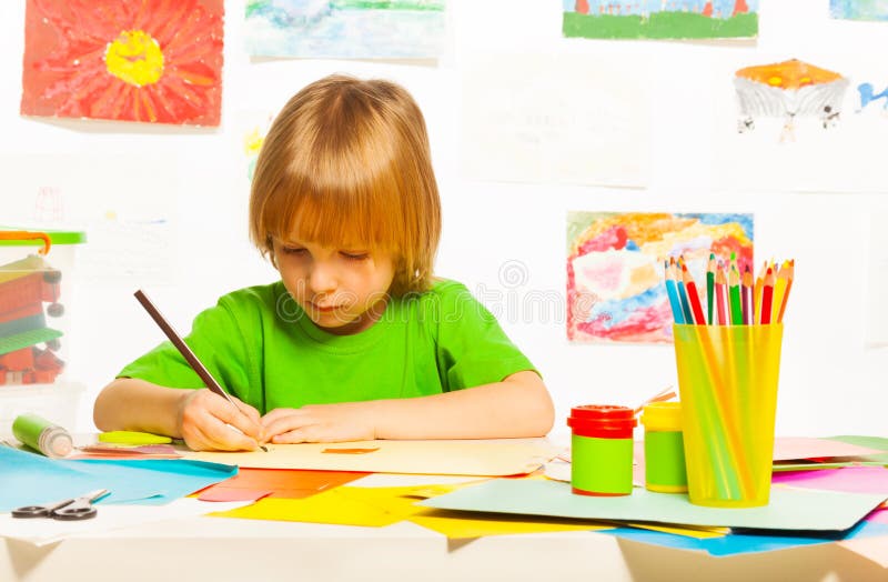 Blond boy drawing royalty free stock photography