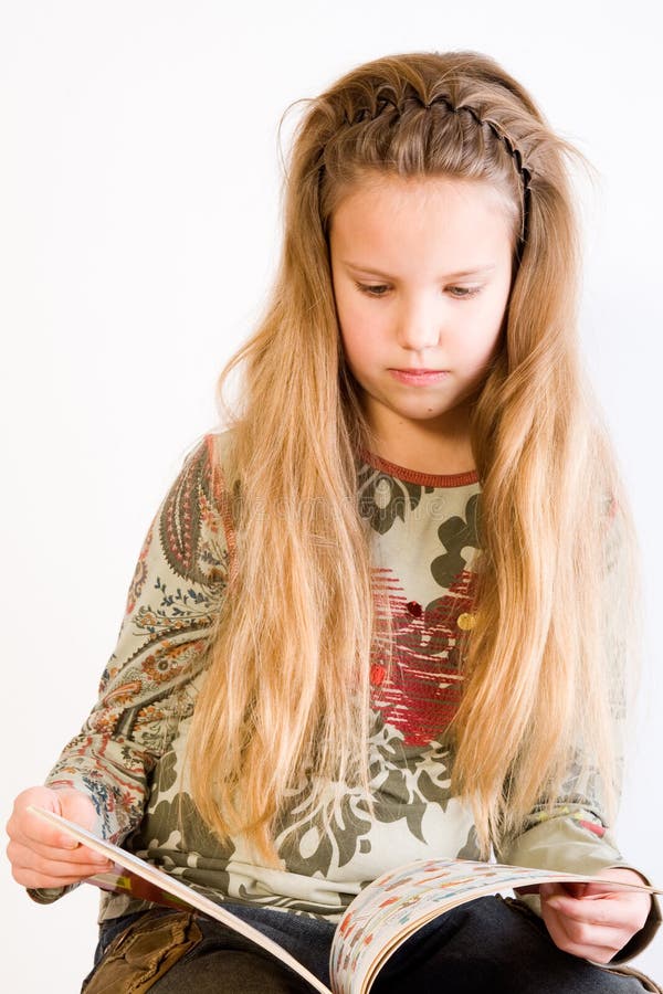 Blond child reading a book