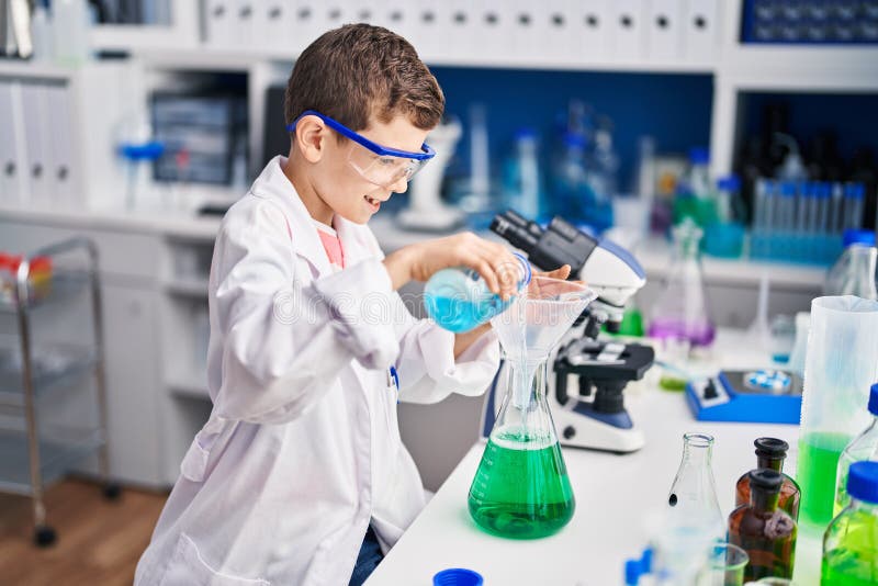 Blond Child Wearing Scientist Uniform Measuring Liquid at Laboratory ...