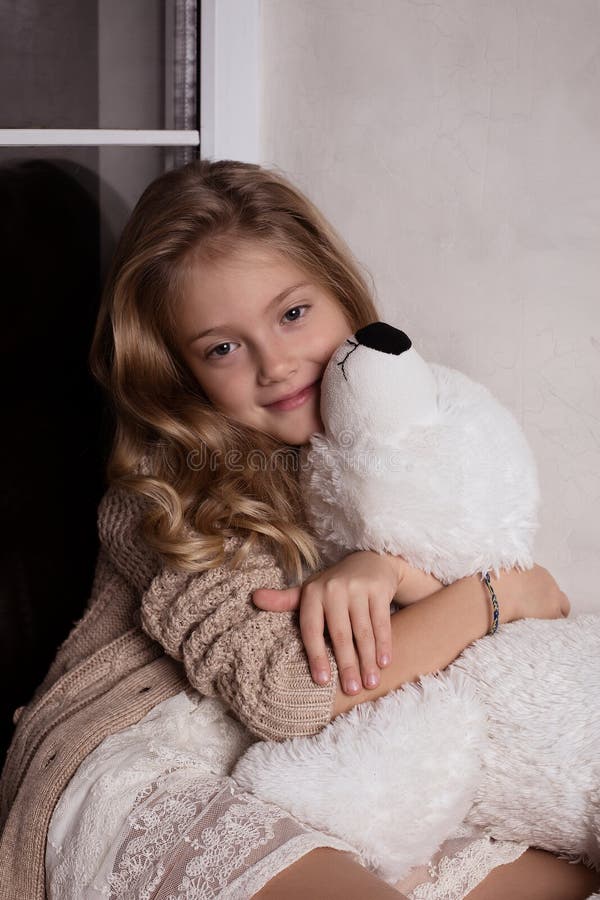 Blond girl with polar bear toy