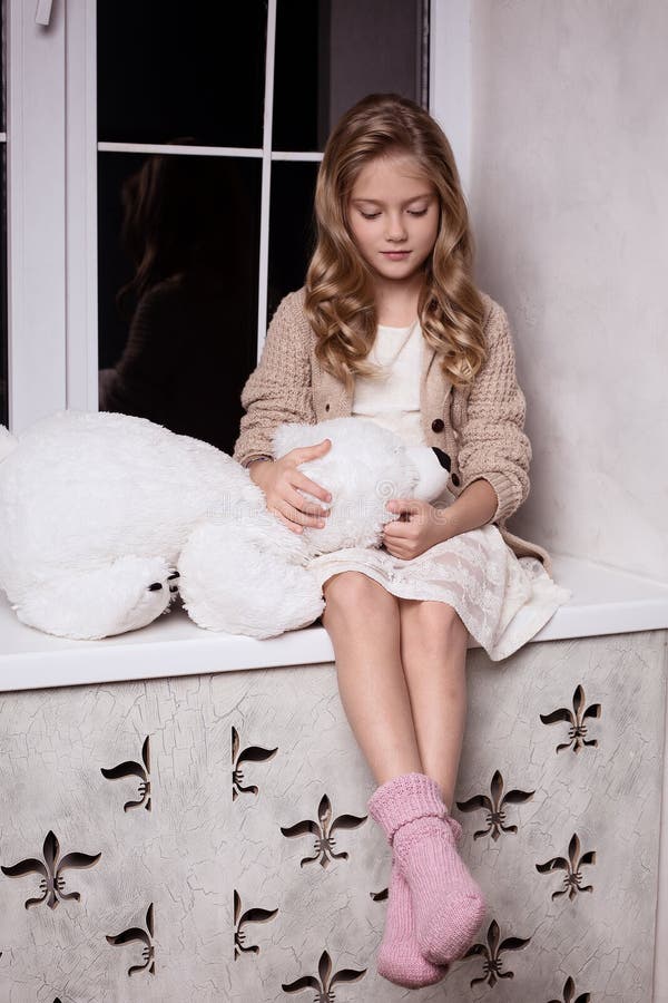 Blond girl with polar bear toy