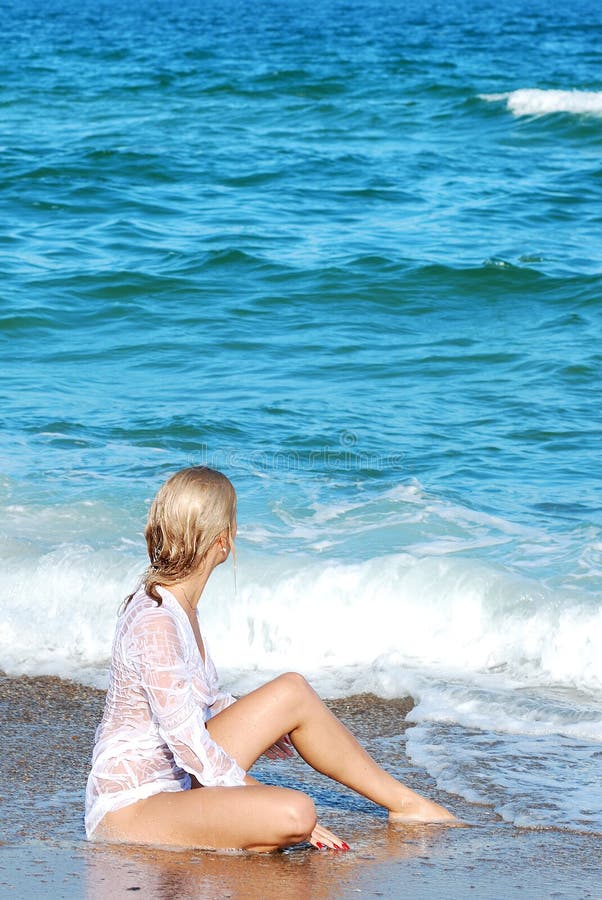 Blond girl on a sea beach