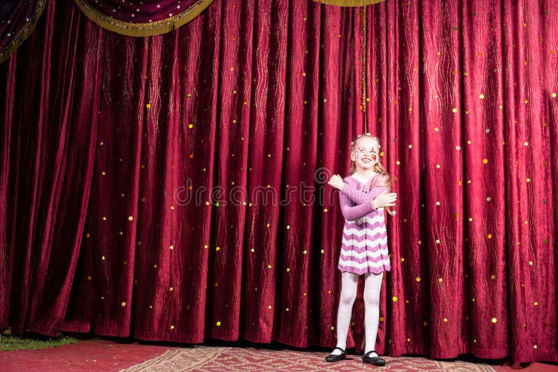 Blond Girl Wearing Clown Make Up Standing on Stage