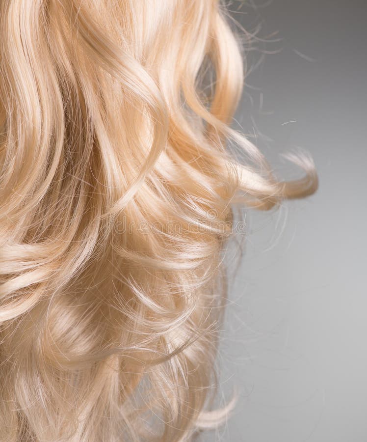 Blond Hair. Beautiful healthy long curly blonde hair close-up texture. Dyed Wavy white hair background, coloring, extensions royalty free stock image Blond Hair. Beautiful healthy long curly blonde hair close-up texture. Dyed Wavy white hair background, coloring, extensions royalty free stock image