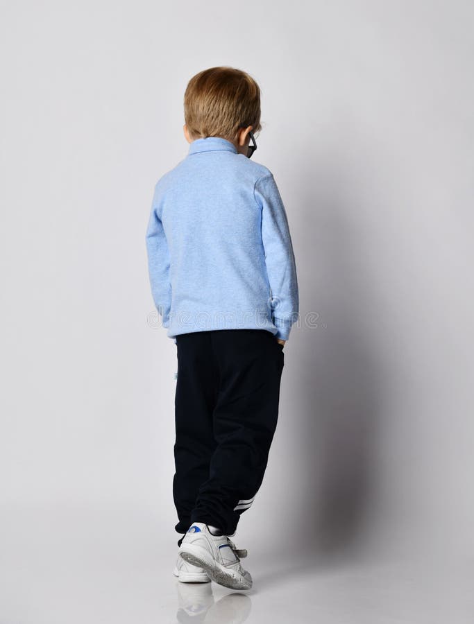 Blond Kid Boy in Sneakers, Black Sport Pants, Blue Turtleneck Sweater ...