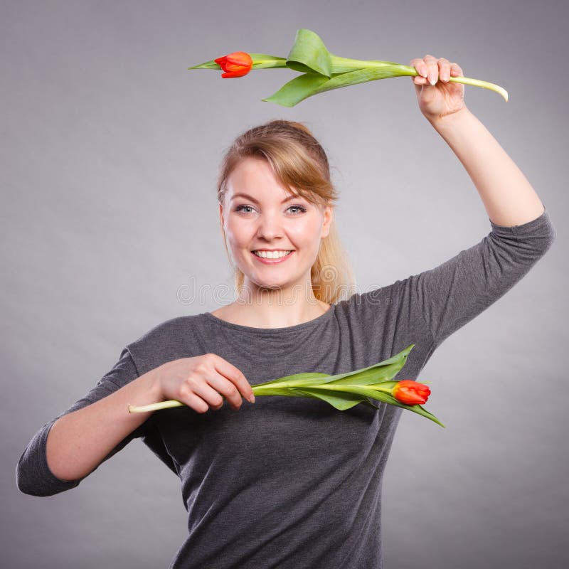 Blond Lady Holding Two Tulips. Stock Photo - Image of waving, symbol ...